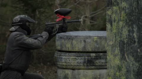 Woman Crouched Firing Paintball Gun