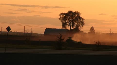 Farming - Tractor Kicks Up Dust In Field