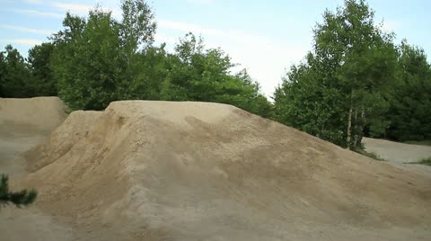 Bmxer Does A Tailwhip Over A Dirt Hip