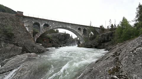 Old Stone Bridge Crossing Waterfall