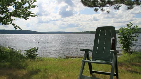 Chair And A Beer On A Beach By The Lake