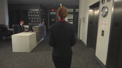 Confident Business Woman Approaches Desk