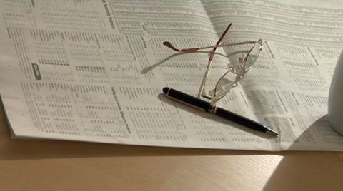 Financial Still Life With Newspaper Coffee And Glasses