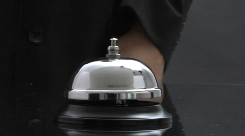 Close Up Of Desk Bell Being Rung
