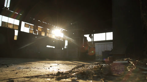 Forklift Moves In An Old Factory At Sunrise.Water Drops Fall In Slow Motion