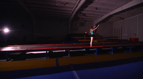 Young Female Gymnast Backflip Wide Shot