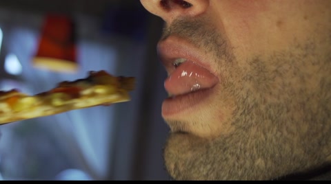 Man Eating Pizza In Closeup In Slow Motion