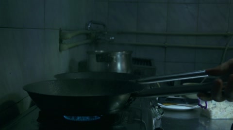 Flame Rises From The Pan In The Kitchen In Slow Motion