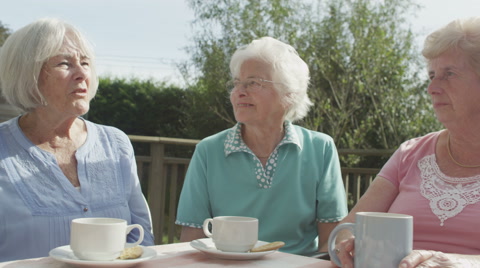 4K Happy Female Senior Friends Chatting And Laughing Together Outdoors
