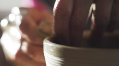 Stock Video Footage Hands Of A Potter Forming Pot On A Potter's Wheel