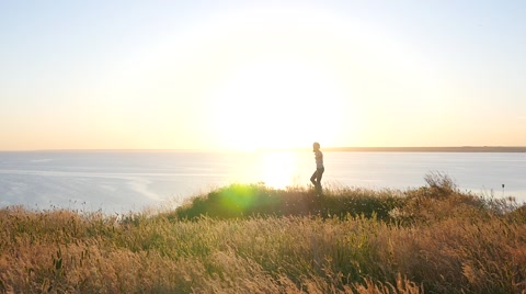 Girl Photographer Shoot On Beautiful Nature Over A Precipice In Golden Sunset