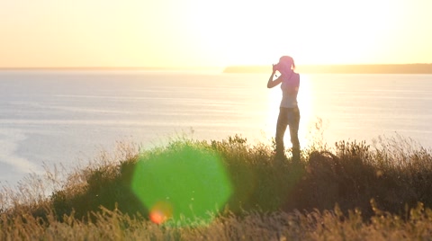 Young Girl Photographer Walking Over A Precipice In Golden Sunset