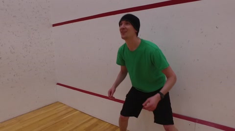Man Playing Dodgeball In A Gymnasium