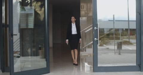 Young Businesswoman Exiting A Modern Office