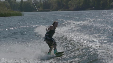 Extreme Sport Wake Boarder Crashing Behind A Boat