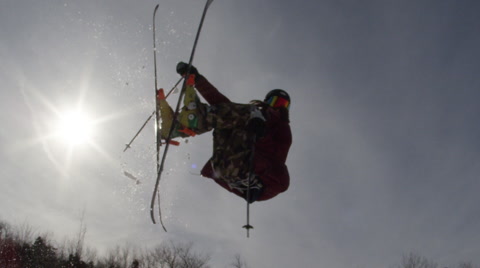 Silhouette Slow Motion Ski Flip Against Blue Sky
