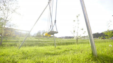 Swing On Beautiful Green Lawn Low Angle Slide