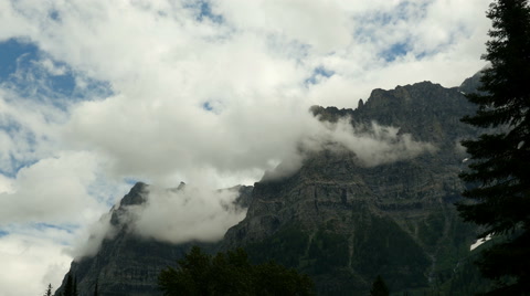 Glacier National Park Mountain Peaks And Moody Clouds