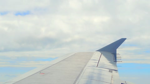 Airplane Wing Under Clouds