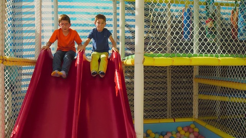 Two Kids Sliding Down To A Ball Pool In Uhd